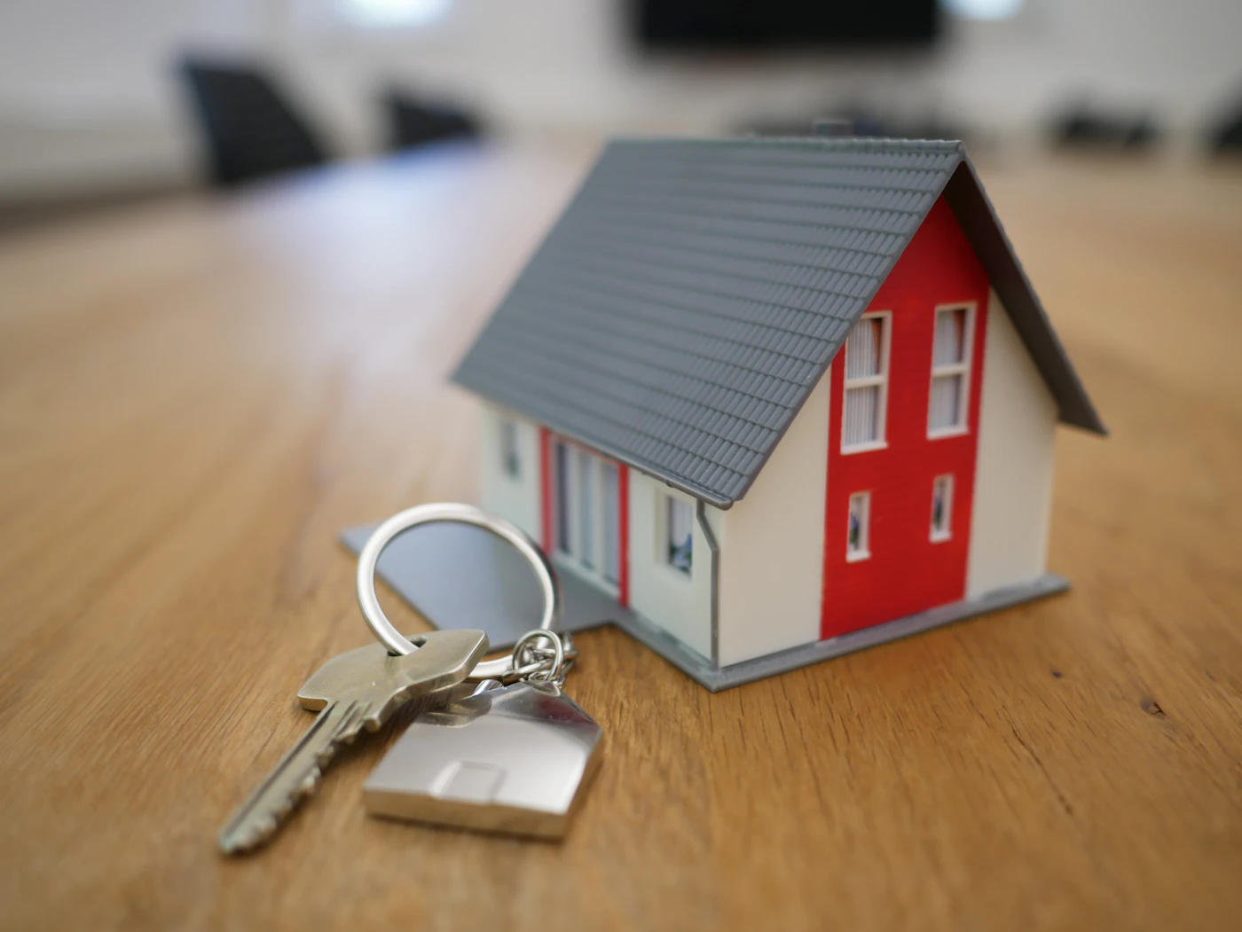 House keys on a table with a small model home